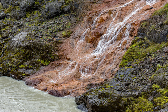 Eastern Iceland, a small waterfall that is flowing down the side of a mountain