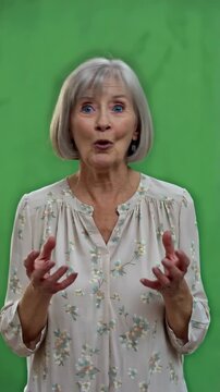White elderly woman on green screen rubs her eyes then stares in baffled comic wonder as if what she sees is impossiblecaucasian