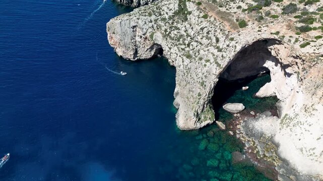 aerial view of Blue Grotto, Malta, limestone arch and turquoise water, Mediterranean coast