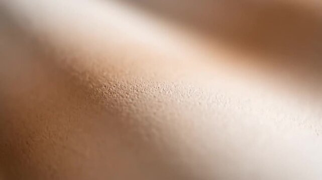 A close-up shot reveals a textured surface with subtle variations in color, creating a visually interesting and abstract pattern that evokes a sense of depth and tactile sensation