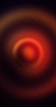 Abstract pulsing animated background. Red and orange grainy gradient circles looping animation. 