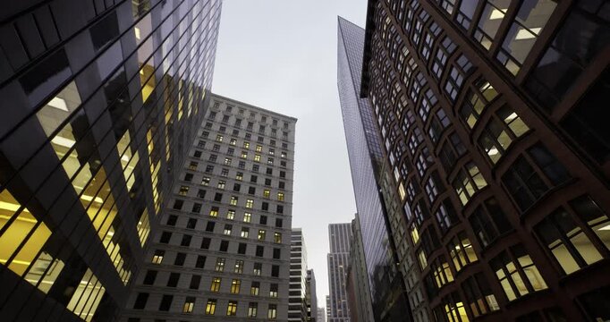 historic masonry meets modern glass towers creating contrast between ornate brick facades, cornices and sleek reflective surfaces in vibrant downtown