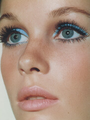 Fototapeta premium Beauty makeup branding – close-up of young woman with blue eyeshadow, mascara and natural lips