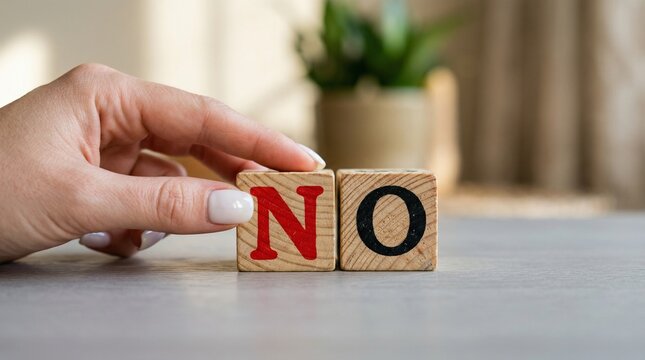 A Defiant Stance: A hand decisively places the NO blocks, a visual assertion of denial and refusal. A powerful emblem of negation, decision-making, and boundary setting.