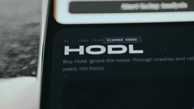 HODL long-term investment strategy used in cryptocurrency markets displayed on smartphone screen