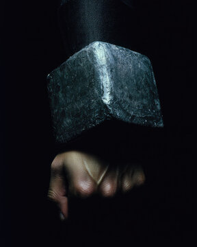 Wrist splint for carpal tunnel support shown on hand in dark background, highlighting protective medical device and strong emotional expression