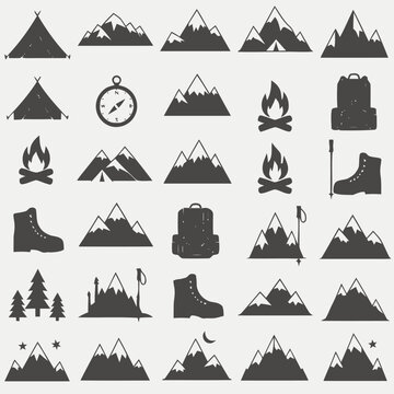 Collection of silhouette icons representing mountain expeditions, including tents, boots, backpacks, and campfires for outdoor adventure themes