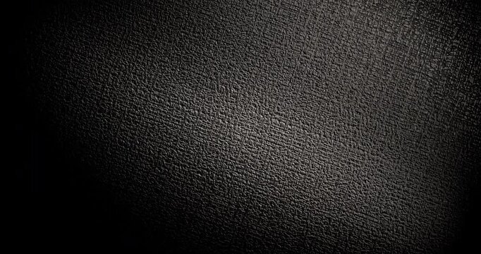 Dark Textured Black Background. Video of rough dark surface with subtle slow light movement and soft shadows.
