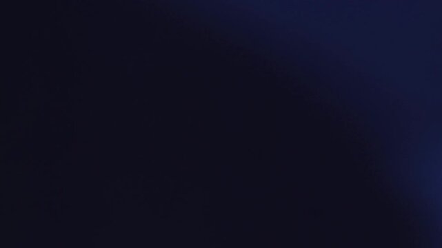  Una toma de cerca de un fondo abstracto de  color azul y negro con un efecto borroso o desenfoque en movimiento. 