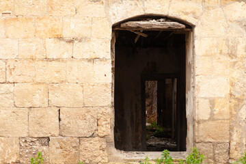 Fototapeta premium stone-walled house with missing doors