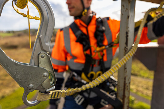 Landscape orientation construction worker at height using fall arrest lanyards