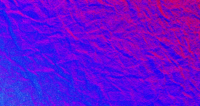 Crumpled Neon Paper Texture Abstract. Seamless loop of crumpled paper surface with sharp folds and wrinkles illuminated by vibrant pink purple and blue neon lighting creating dramatic color shifts.