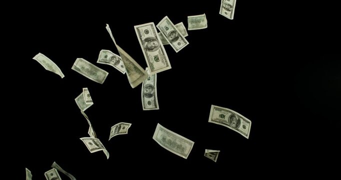 US dollar banknotes flying in super slow motion against black background. Floating money bills drifting and falling in the air, symbolizing wealth, finance and luxury in cinematic detail.