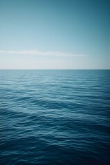Fototapeta premium Calm ocean surface under a clear blue sky