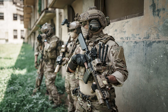 Special forces soldiers in tactical gear during a training exercise outdoors