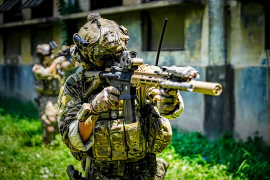 Special forces soldier aiming firearm in tactical gear during training exercise