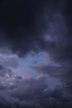 Storm sky with dark grey blue violet cumulus rainy clouds abstract background texture, thunderstorm
