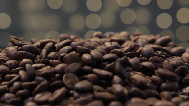 Coffee beans falling from above forming a pile, close-up