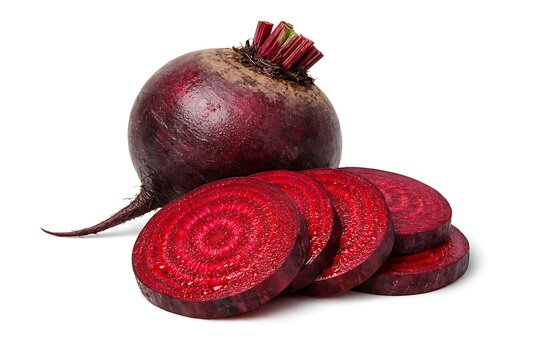 Whole and sliced deep red beetroot with earthy skin on white background