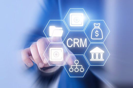 Business professional interacting with CRM software icons in a modern office setting during the daytime