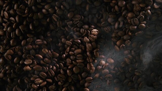 Aerial top view Industrial roasting process of coffee beans with smoke in roaster.
