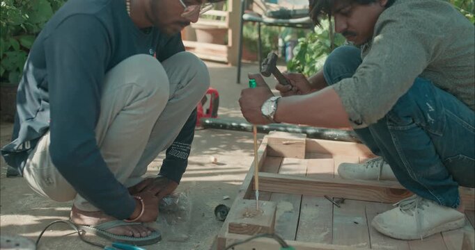 Beginner carpenter using professional tools while working on wood, capturing real workshop moments and skill development in action