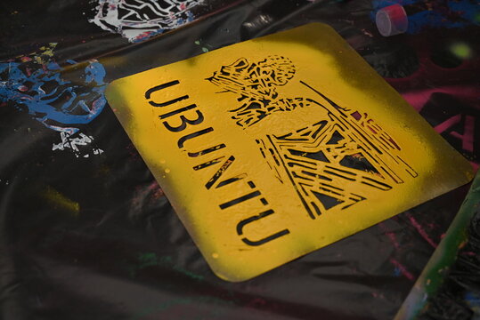 A spraypaint stencil saying the word Ubuntu at a spray paint  graffiti event in Johannesburg.