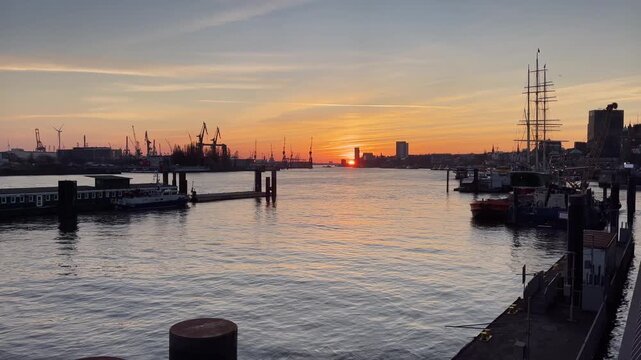 Sunset over the Port of Hamburg at Elbpromenade, Jan-Fedder-Promenade. Container Cranes in the Background.