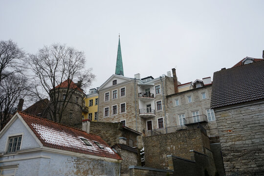 Historical city buildings and rooftops with a spire