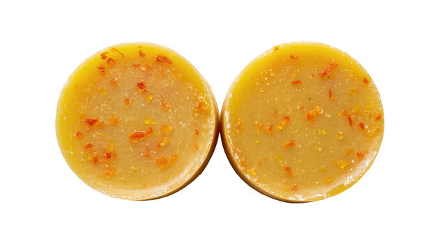 Two round orange zest soaps with visible zest pieces, isolated on transparent background