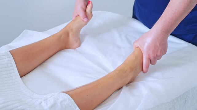 Enjoy a soothing massage of the feet and legs at a serene spa salon with a professional therapist. Experience ultimate relaxation.