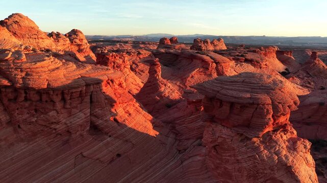 Aerial view of the vibrant red rock formations sculpted by wind and time, creating a maze of textures and shadows, Marble Canyon, Arizona, United States.