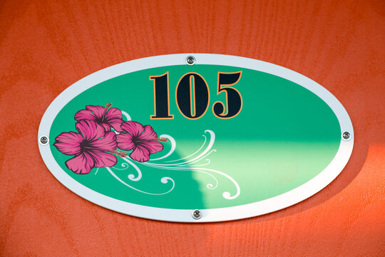 Retro motel room number 105 with floral oval sign