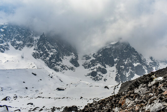 Snow-covered Himalayan valley with rugged peaks, clouds, at Kala Patthar, North Sikkim, India.