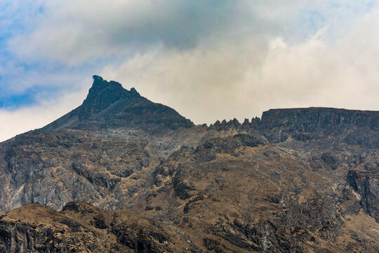 Rugged rocky Himalayan peaks under dramatic clouds, high-altitude landscape at North Sikkim, India.