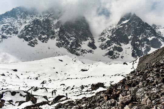 Snow-covered Himalayan valley with rugged peaks, clouds, at Kala Patthar, North Sikkim, India.
