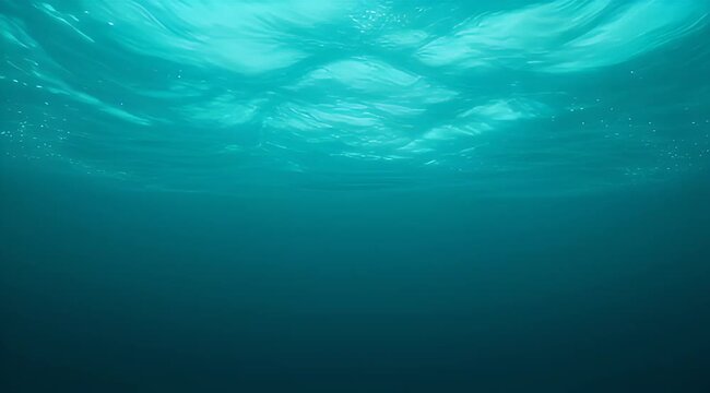 An eyelevel shot of deep blue ocean water from an underwater perspective