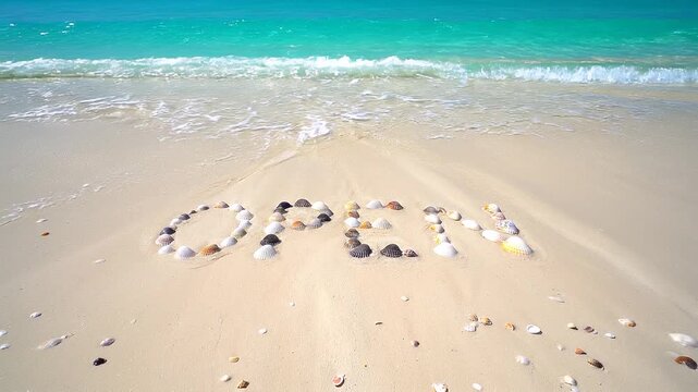 Ocean Wave Reveals &ldquo;OPEN&rdquo; Message Made of Seashell Letters on Sunny Beach
