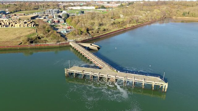 Aerial view of Anglian Water Cliff Quay WRC outfall, a landscape where industrial structures meet the serene waters in a contrasting display, Ipswich, England, United Kingdom.