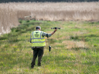 Usk Monmouthshire Wales UK April 03 2026 drone pilot with battery powered drone lifting off © Cliff