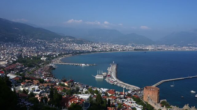 Panoramic Aerial View of Alanya City Harbor and Red Tower, Kizil Kule Landmark, Turkish Riviera Landscape with Mediterranean Sea, Antalya Coastline. Urban Travel Concept, Ancient Turkish Castle.