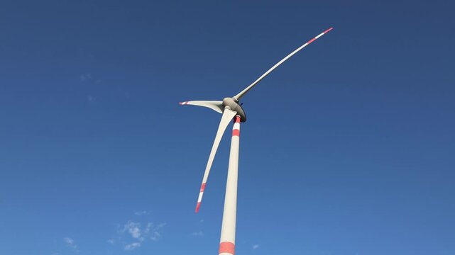 Generatore eolico a tre pale su sfondo azzurro del cielo