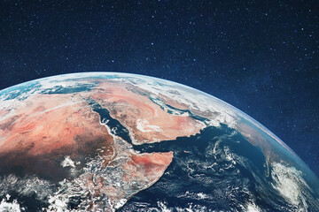 Wide-angle orbital view of Earth featuring the Red Sea, Nile River, and Arabian Peninsula. The planet's curve meets a deep black space filled with stars, highlighting desert terrains and blue oceans.