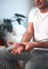 Fototapeta premium Man with hand, wrist pain, injury at home.