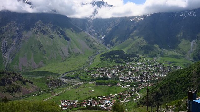 Scenic Aerial View of Stepantsminda Village in Georgia, Caucasus Mountains Landscape with Lush Green Valley, Kazbegi Rural Town Background. Adventure Travel and Tourism Concept, Majestic Nature
