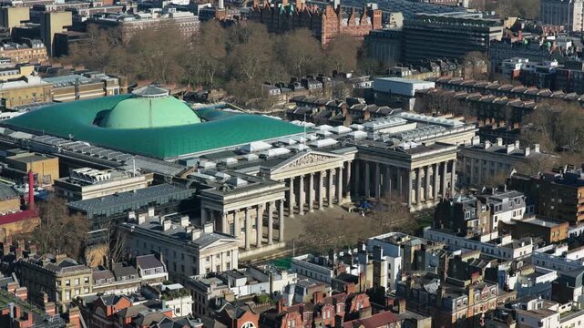 High angle scene capturing British Museum with its distinctive Great Court roof, masterpiece of modern design contrasting with neoclassical facade in Bloomsbury area of London