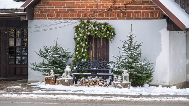 Outdoor Christmas decorations with bench and lanterns in winter.