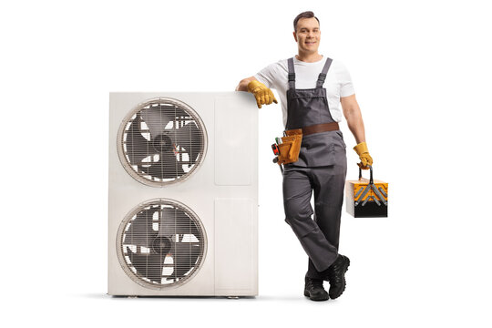 HVAC technician leaning on an outdoor air conditioning unit