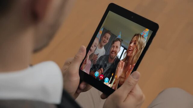 Joyful businessman make call holding tab computer at room closeup. Family video