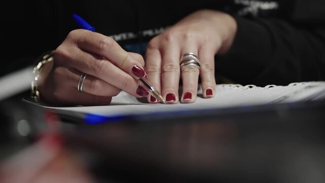 Woman's Hands Writing Notes in a Notebook for Study or Work